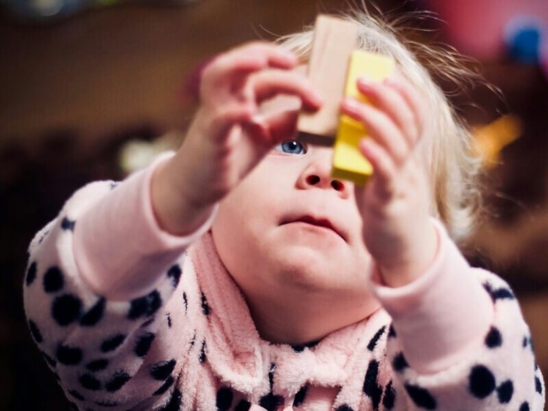 A baby playing with blocks.