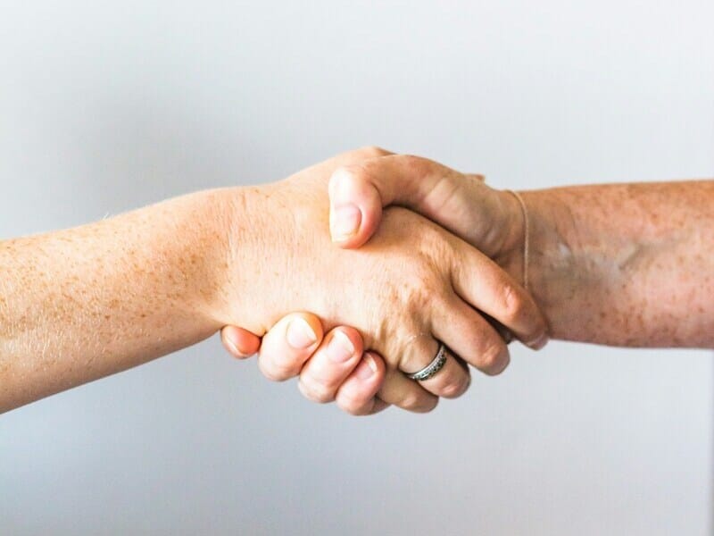 A photograph of a handshake.